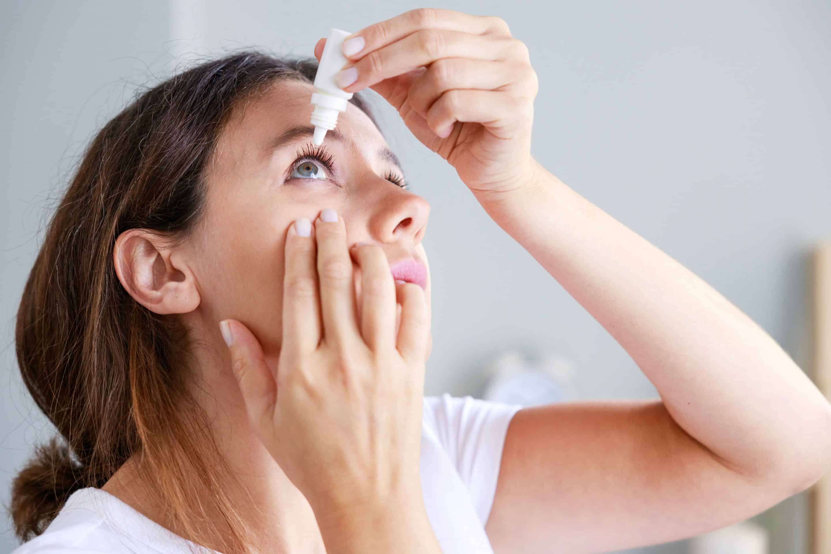 Woman using eye drops for dry eyes in Mountain Brook AL